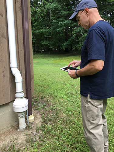 inspecting drainage on house