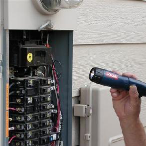 inspecting fuse box with flashlight